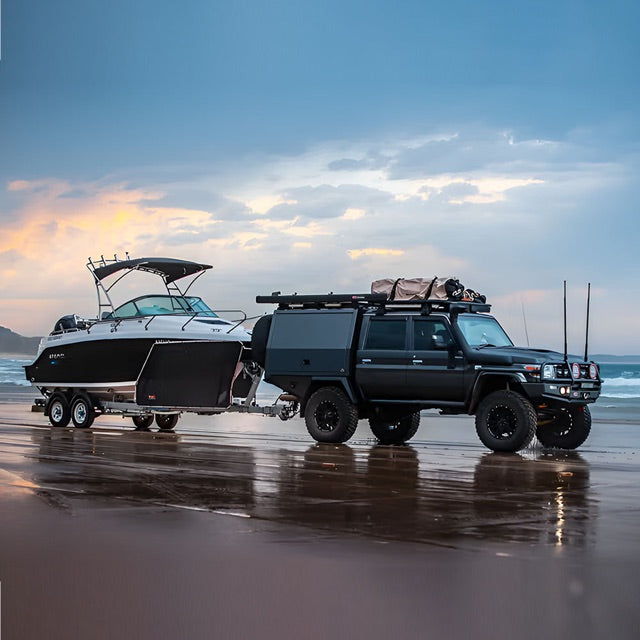 A boat on its trailer at sunset with the guard fitted